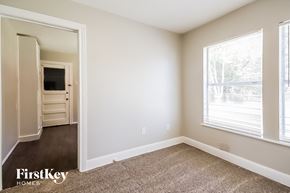 Baytown house for rent - A carpeted room with a doorway leading to another room.