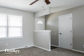 Lee's Summit house for rent - A room with a ceiling fan and a window with blinds.
