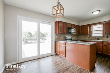 Lee's Summit house for rent - A kitchen with wooden cabinets and a large island.