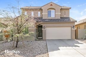 San Tan Valley house for rent - a beige house with a garage door and a tree