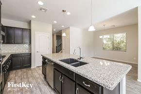 San Tan Valley house for rent - a kitchen with a granite counter top and a sink