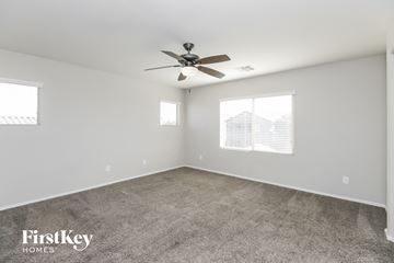 San Tan Valley house for rent - a living room with carpet and a ceiling fan