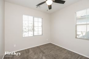 San Tan Valley house for rent - a bedroom with a ceiling fan and two windows