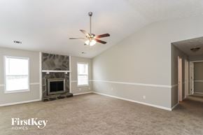 Woodstock house for rent - an empty living room with a ceiling fan and a fireplace