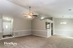 Woodstock house for rent - the living room of an empty house with a ceiling fan