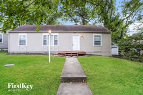 Kansas City house for rent - a white house with a yard and a sidewalk in front of it