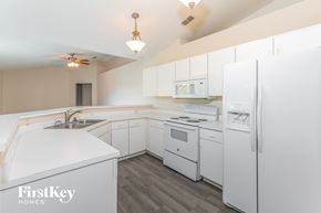 Poinciana house for rent - a white kitchen with white appliances and white cabinets