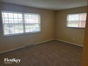Cincinnati house for rent - A room with a carpeted floor and two windows.