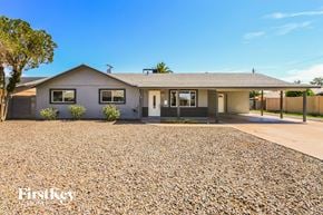 Chandler house for rent - a small house with a gravel driveway and a roof