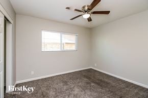 Chandler house for rent - a bedroom with a ceiling fan and a window