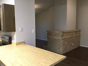 Forney house for rent - A kitchen with a wooden counter top and a brick wall.
