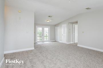 Saint Cloud house for rent - a spacious living room with white walls and white carpet