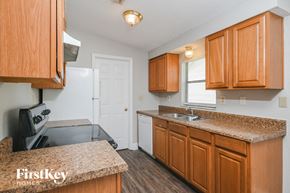 Saint Cloud house for rent - a kitchen with wood cabinets and granite counter tops and a sink
