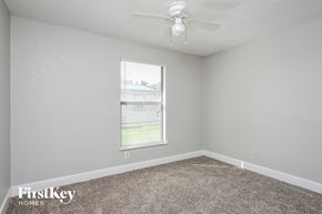 Saint Cloud house for rent - a bedroom with carpet and a ceiling fan