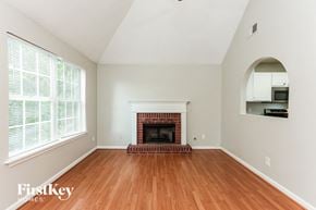 Austell house for rent - A room with a fireplace and a mirror on the wall.