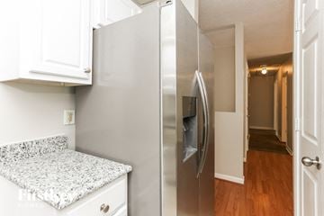 Austell house for rent - A stainless steel refrigerator with a water and ice dispenser in a kitchen.