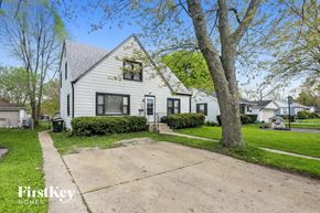 Winthrop Harbor house for rent - a white house with a driveway and trees in front of it