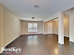 Anna house for rent - an empty living room with hardwood floors and a window
