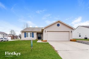 Bargersville house for rent - a white and blue house with a driveway and lawn