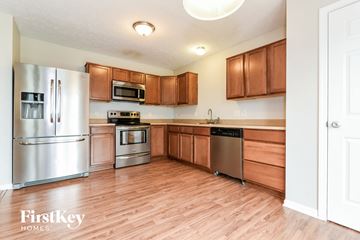 Bargersville house for rent - a kitchen with wooden floors and stainless steel appliances
