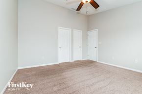 Bargersville house for rent - a bedroom with two doors and a ceiling fan