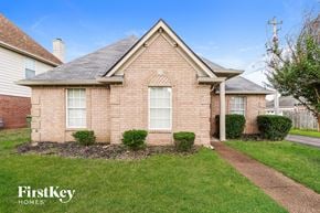 Cordova house for rent - A brick house with a well-maintained lawn in front.