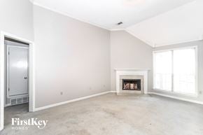 Cordova house for rent - A spacious living room with a fireplace and a door on the left.