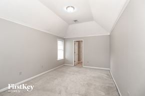 Cordova house for rent - A spacious empty room with a doorway leading to another room.
