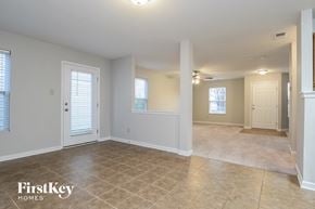 Monroe house for rent - the living room and dining room of an empty house