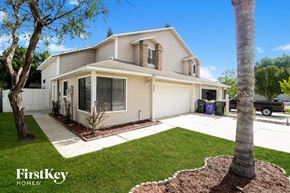 Rockledge house for rent - a white and tan house with a yard and a tree