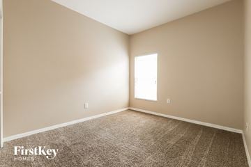 Seffner house for rent - the living room of a new home with carpet and a window