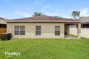 Seffner house for rent - a home with a grass yard and a garage