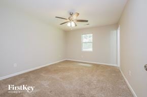 Senoia house for rent - the master bedroom has carpet and a ceiling fan