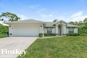 Palm Bay house for rent - a white house with a lawn and a garage door