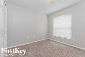 Palm Bay house for rent - a bedroom with carpet and a large window