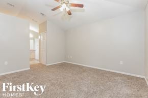 Palm Bay house for rent - the spacious living room with carpeting and a ceiling fan