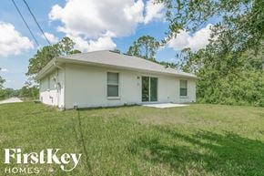 Palm Bay house for rent - a small white house with a lawn and trees