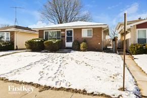 Calumet City house for rent - a brick house with a yard covered in snow