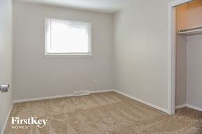 Calumet City house for rent - a bedroom with a closet and a window