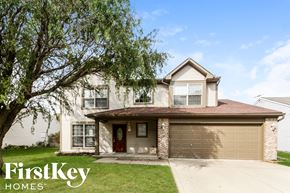 Brownsburg house for rent - A house with a brown roof and a garage door is for sale by FirstKey Homes.