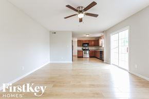 Brownsburg house for rent - A spacious room with a ceiling fan and wooden flooring.
