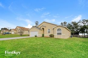Lake Wales house for rent - a beige house with a lawn in front of it