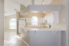 Lake Wales house for rent - a kitchen with white cabinets and a white counter top