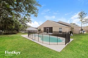 Lake Wales house for rent - a pool in the backyard of a house with a fence around it