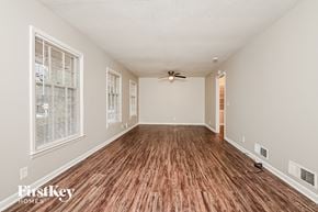 Conyers house for rent - a living room with a hard wood floor and a ceiling fan