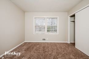 Conyers house for rent - a bedroom with carpet and a window and a closet