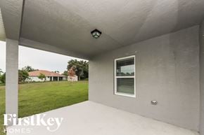 Port St. Lucie house for rent - an empty patio in a home with a grass field in the background