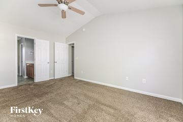 Knightdale house for rent - a living room with carpet and a ceiling fan