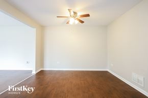 University Park house for rent - a living room with wood floors and a ceiling fan