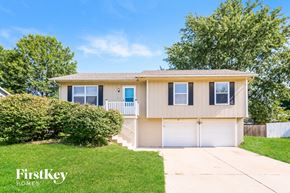 Peculiar house for rent - a beige house with a white garage door